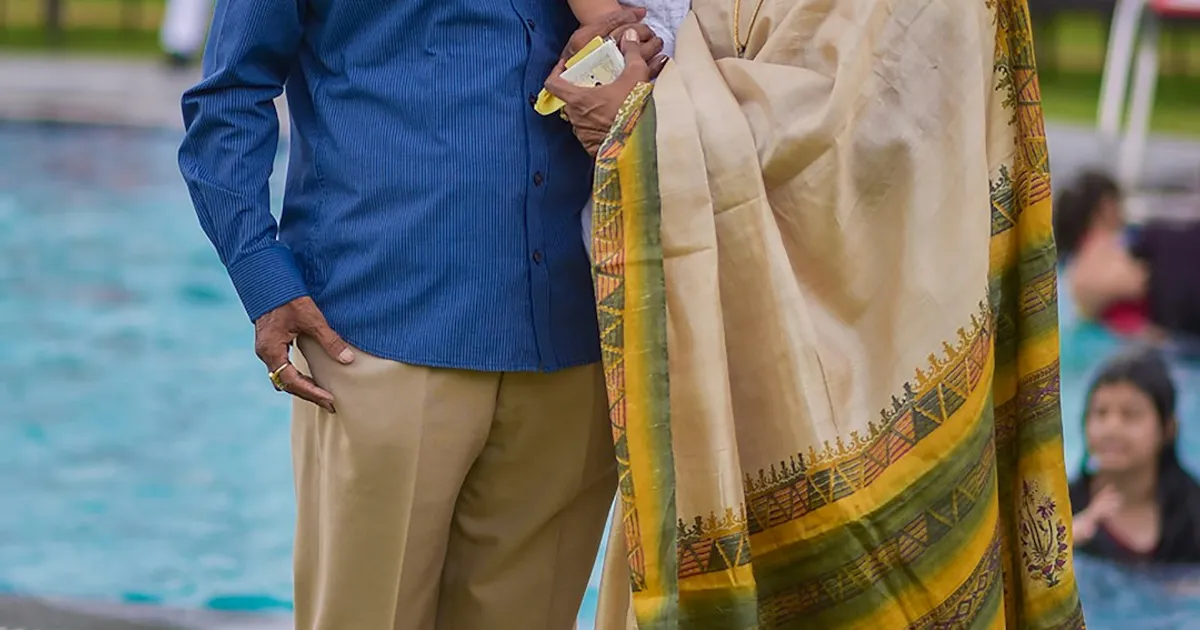 A South Asian grandmother smiling warmly with her family, representing the memories that keep a grandparent's spirit alive