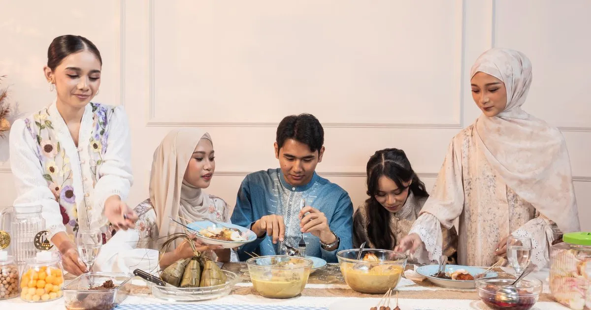 A Pakistani family celebrating Eid together with traditional food and decorations