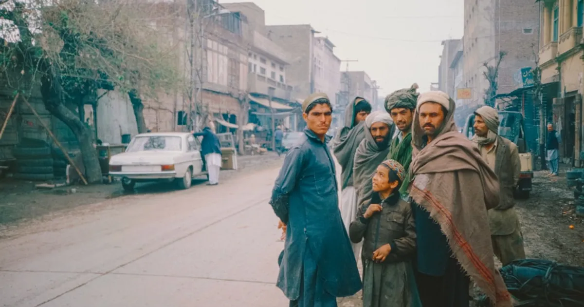 An elderly South Asian man sitting with family, representing the urgency of preserving stories before memory loss