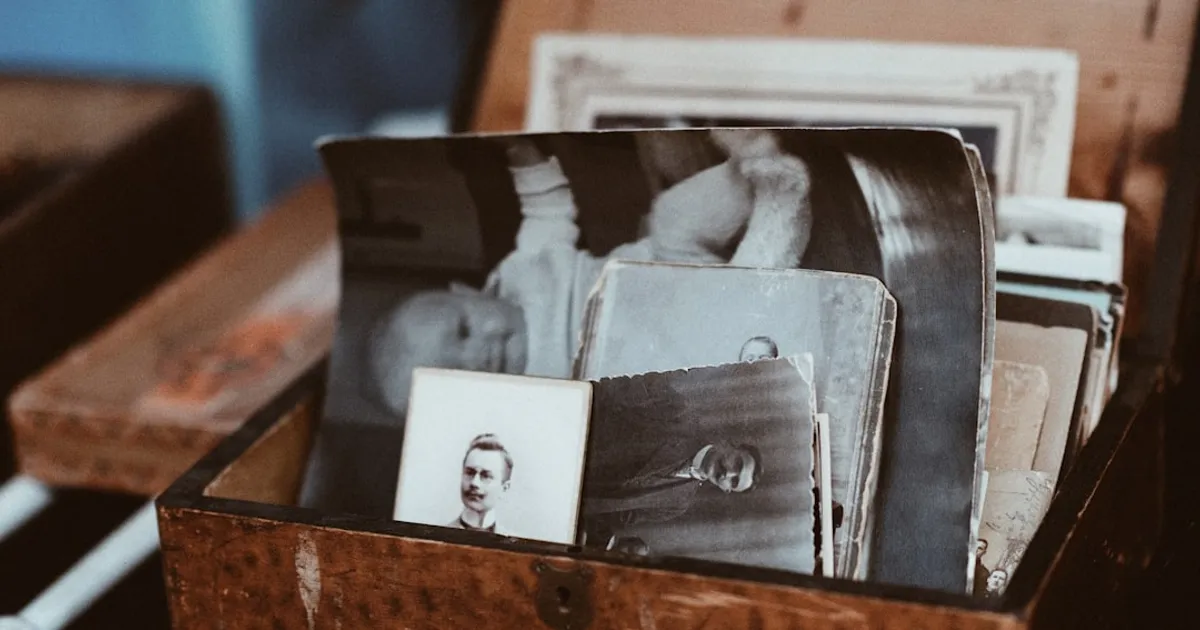 Old photographs stored in a brown wooden chest, representing family memories and generational heritage waiting to be preserved